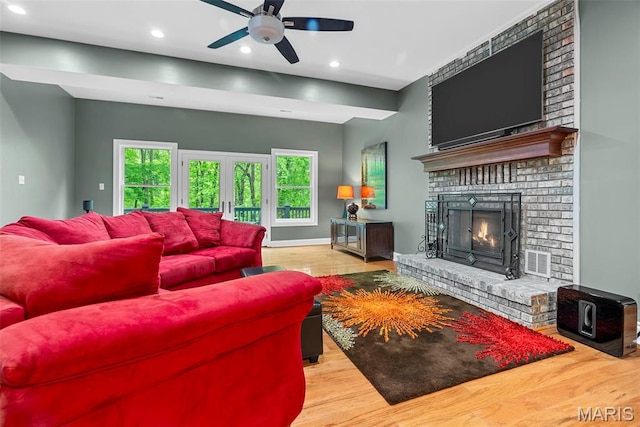 1424 Haarman Oak Dr, Wildwood, MO 63005 - living room featuring a brick fireplace, ceiling fan, wood finished floors, recessed lighting, and baseboards