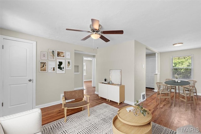 4717 Roxie St, Saint Louis, MO 63121 - living room featuring wood finished floors, baseboards, and a ceiling fan