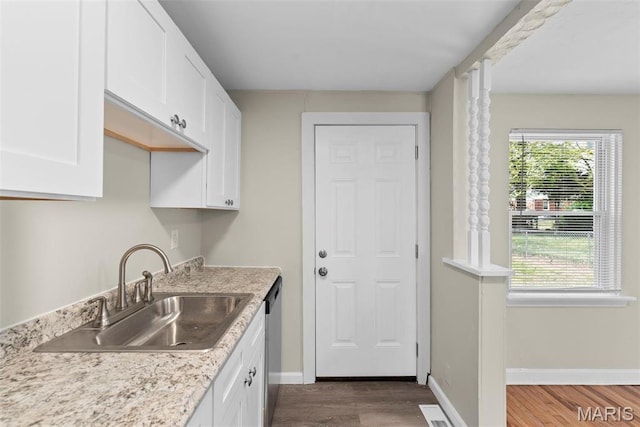 4717 Roxie St, Saint Louis, MO 63121 - kitchen with a sink, white cabinetry, dark wood-style floors, and stainless steel dishwasher