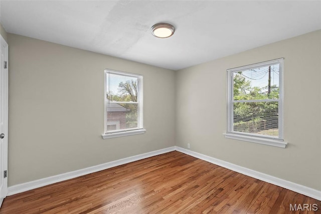 4717 Roxie St, Saint Louis, MO 63121 - spare room featuring wood finished floors and baseboards