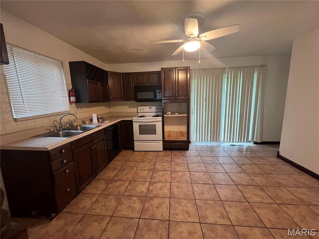 6145 Payne Ave, Saint Louis, MO 63135 - kitchen with black appliances, a ceiling fan, a sink, and dark brown cabinets