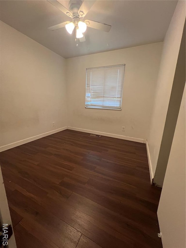 6145 Payne Ave, Saint Louis, MO 63135 - empty room with dark wood-type flooring, baseboards, and ceiling fan
