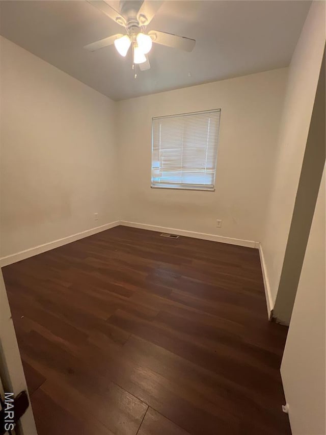 6145 Payne Ave, Saint Louis, MO 63135 - empty room with dark wood finished floors, baseboards, and a ceiling fan