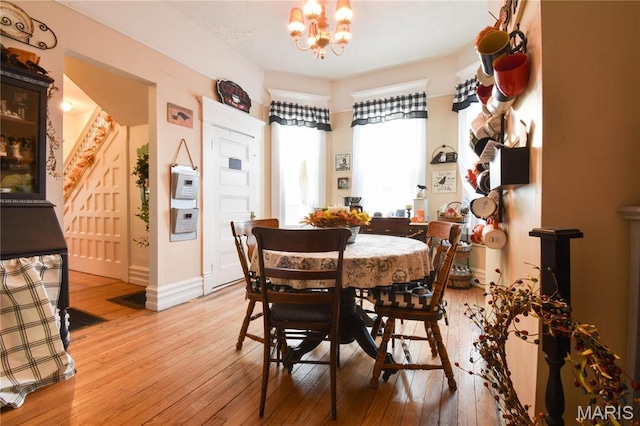 120 E Corbin St, Bethalto, IL 62010 - dining room with light wood-style flooring, a chandelier, and baseboards
