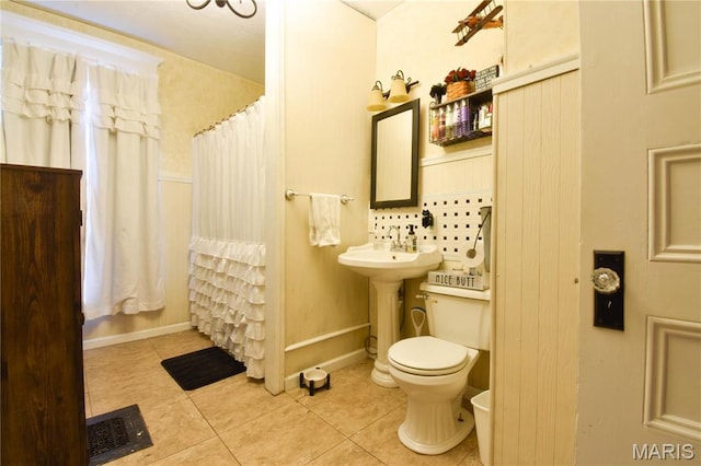 120 E Corbin St, Bethalto, IL 62010 - bathroom with tile patterned flooring, toilet, backsplash, a shower with shower curtain, and baseboards