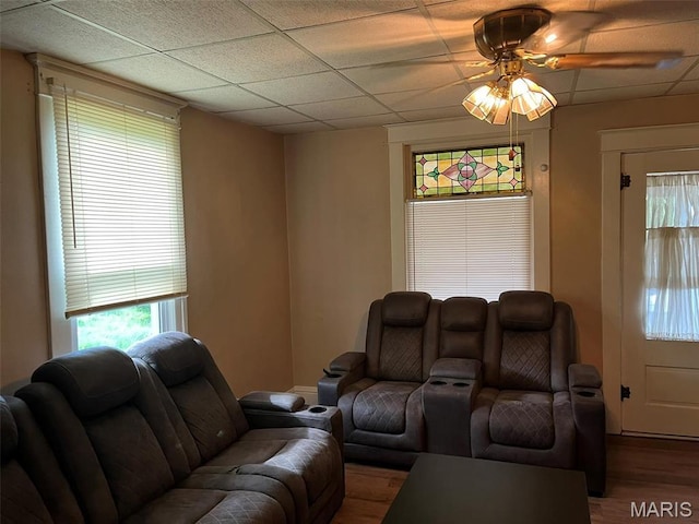 living room featuring wood finished floors, a ceiling fan, and a paneled ceiling