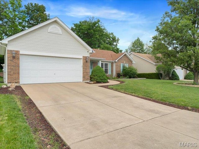 927 Annabrook Park Dr, Ofallon, MO 63366 - ranch-style house with brick siding, driveway, a front yard, and a garage