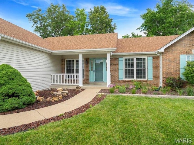 927 Annabrook Park Dr, Ofallon, MO 63366 - view of front facade featuring brick siding, a porch, a front yard, and roof with shingles