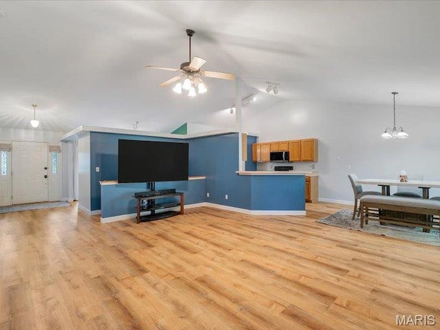 927 Annabrook Park Dr, Ofallon, MO 63366 - living area featuring vaulted ceiling, a ceiling fan, baseboards, light wood finished floors, and a chandelier