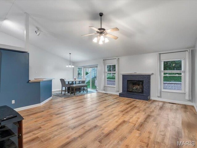 927 Annabrook Park Dr, Ofallon, MO 63366 - living room featuring lofted ceiling, ceiling fan, baseboards, wood finished floors, and a fireplace
