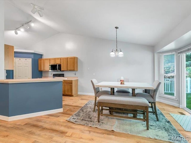 927 Annabrook Park Dr, Ofallon, MO 63366 - dining space with track lighting, lofted ceiling, a chandelier, baseboards, and light wood finished floors