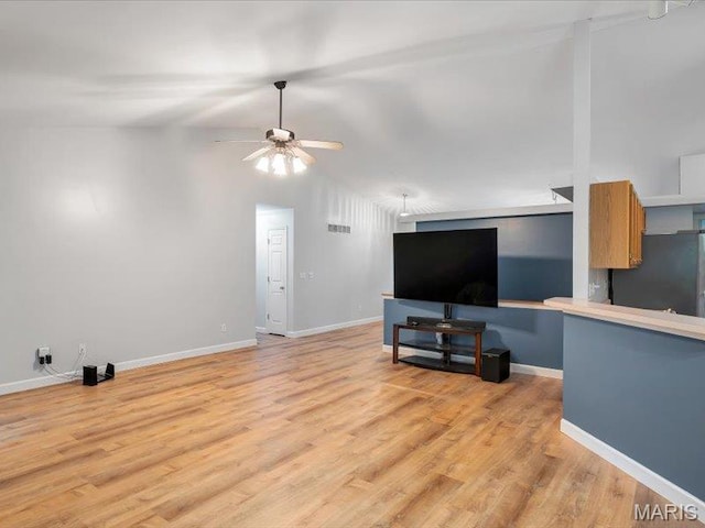 927 Annabrook Park Dr, Ofallon, MO 63366 - unfurnished living room featuring a ceiling fan, light wood-style flooring, baseboards, and vaulted ceiling