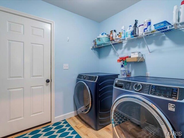 927 Annabrook Park Dr, Ofallon, MO 63366 - washroom with washer and clothes dryer, light wood finished floors, and baseboards