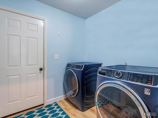 927 Annabrook Park Dr, Ofallon, MO 63366 - laundry area with independent washer and dryer, wood finished floors, and baseboards