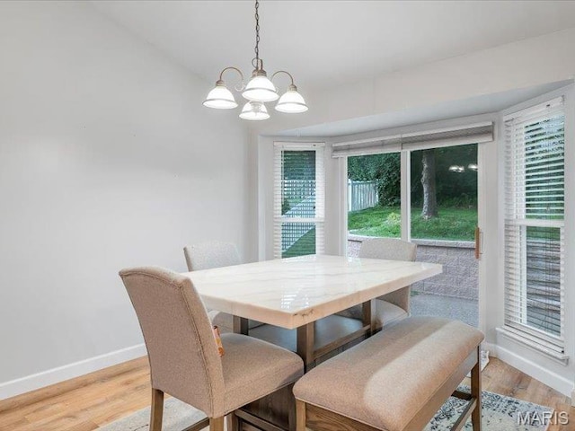 927 Annabrook Park Dr, Ofallon, MO 63366 - dining space with baseboards, a chandelier, and light wood-type flooring