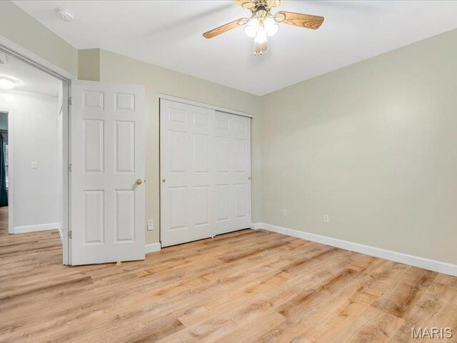 927 Annabrook Park Dr, Ofallon, MO 63366 - unfurnished bedroom with light wood-style flooring, baseboards, a closet, and a ceiling fan