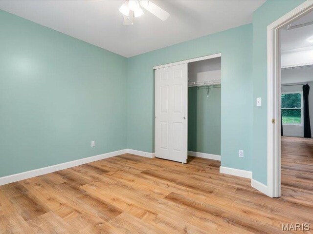 927 Annabrook Park Dr, Ofallon, MO 63366 - unfurnished bedroom with baseboards, light wood finished floors, a closet, and a ceiling fan