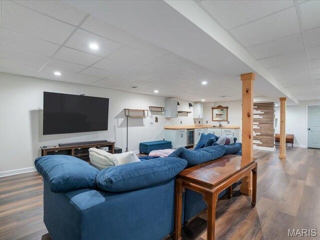 927 Annabrook Park Dr, Ofallon, MO 63366 - living room with dark wood finished floors, baseboards, beverage cooler, a drop ceiling, and recessed lighting