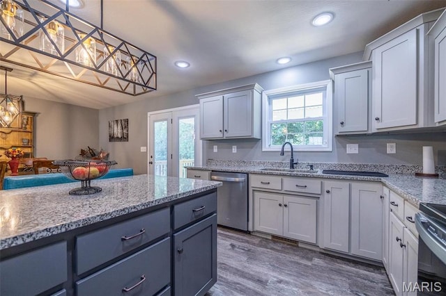 1541 Fairfield Dr, Lebanon, MO 65536 - kitchen with stainless steel appliances, a sink, plenty of natural light, light stone counters, and recessed lighting