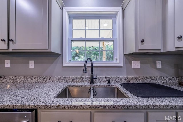 1541 Fairfield Dr, Lebanon, MO 65536 - kitchen with a sink, stainless steel dishwasher, light stone counters, and white cabinets