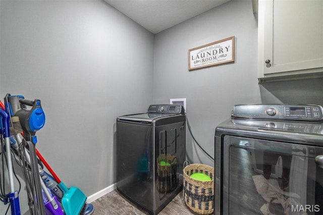 1541 Fairfield Dr, Lebanon, MO 65536 - clothes washing area featuring independent washer and dryer, cabinet space, and baseboards