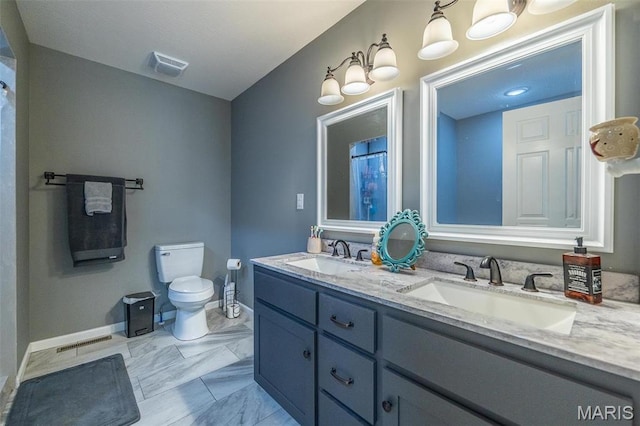 1541 Fairfield Dr, Lebanon, MO 65536 - bathroom featuring toilet, baseboards, marble look tile flooring, and double vanity