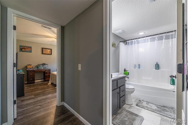 1541 Fairfield Dr, Lebanon, MO 65536 - full bathroom with vanity, shower / tub combo with curtain, baseboards, toilet, and wood finished floors