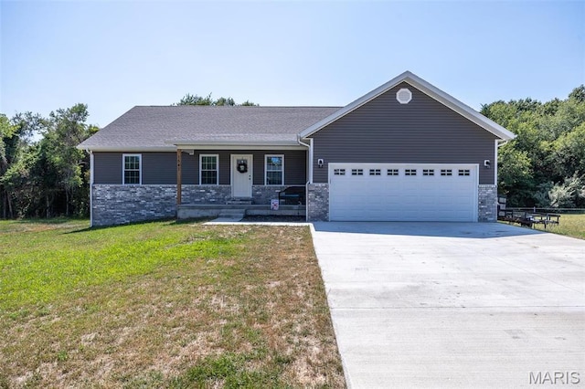 1541 Fairfield Dr, Lebanon, MO 65536 - view of front of home with an attached garage, concrete driveway, a front lawn, covered porch, and stone siding