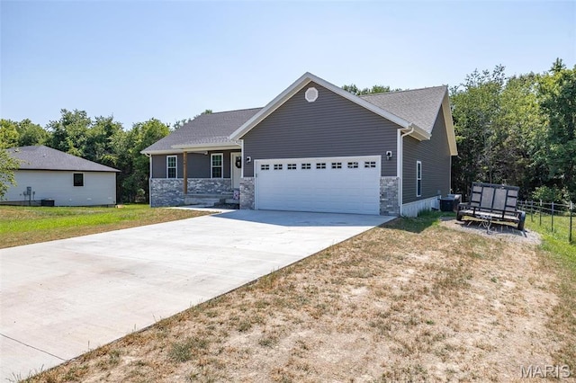 1541 Fairfield Dr, Lebanon, MO 65536 - ranch-style home featuring an attached garage, driveway, stone siding, and a front yard