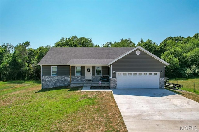 1541 Fairfield Dr, Lebanon, MO 65536 - ranch-style home with covered porch, a garage, concrete driveway, stone siding, and a front yard