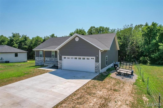 1541 Fairfield Dr, Lebanon, MO 65536 - view of front of house featuring a garage, concrete driveway, stone siding, and central AC unit