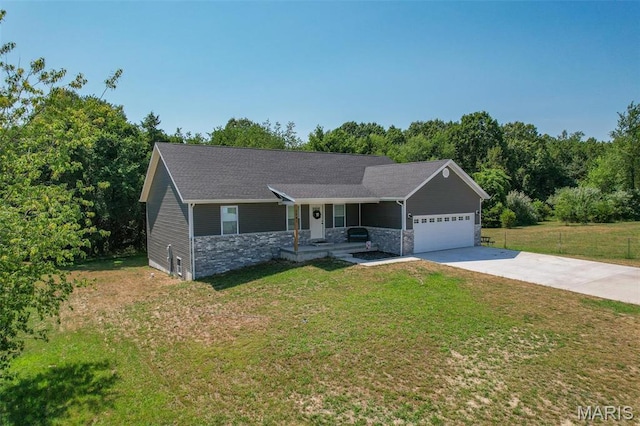 1541 Fairfield Dr, Lebanon, MO 65536 - ranch-style home with a porch, concrete driveway, a garage, stone siding, and a front lawn