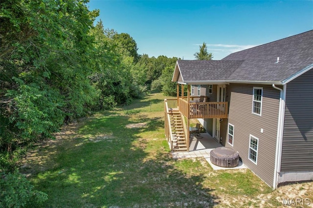 1541 Fairfield Dr, Lebanon, MO 65536 - view of grassy yard with stairway, a wooden deck, and a hot tub