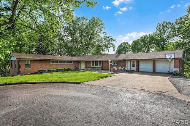 11 Wilshire St, East Alton, IL 62024 - ranch-style house featuring brick siding, a garage, concrete driveway, a front yard, and a chimney