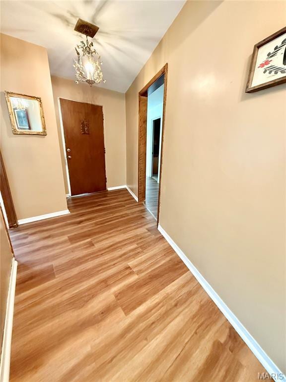 11 Wilshire St, East Alton, IL 62024 - hallway featuring light wood-style floors, baseboards, and a chandelier