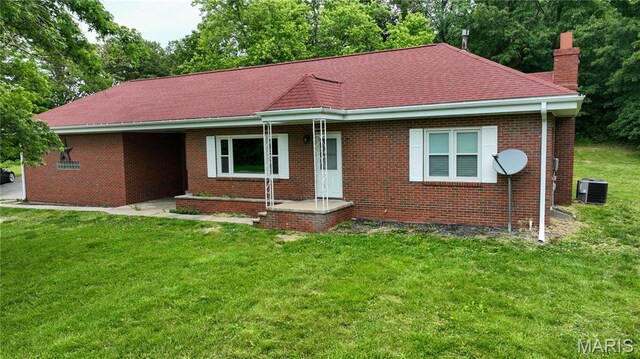 5007 Seiler Rd, Dorsey, IL 62021 - view of front of home with a chimney, a front lawn, brick siding, and central air condition unit