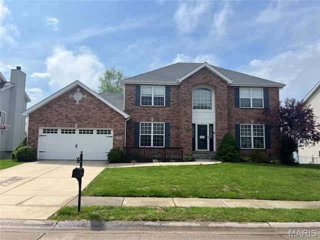 2240 Birmingham Dr, Shiloh, IL 62221 - colonial-style house featuring brick siding, an attached garage, driveway, a front yard, and roof with shingles