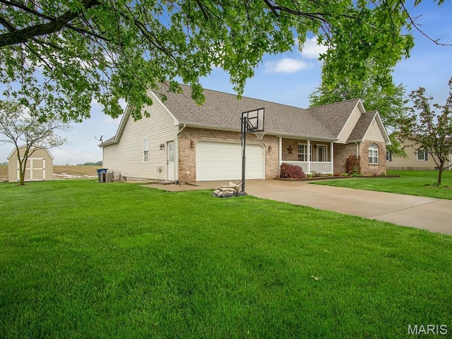 view of front of home with brick siding, a shed, an attached garage, a front yard, and roof with shingles