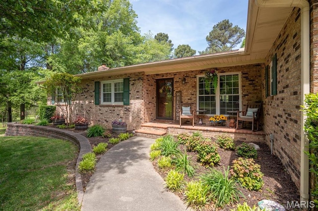 16785 County Road 624, Dexter, MO 63841 - doorway to property featuring brick siding, covered porch, a chimney, and a lawn