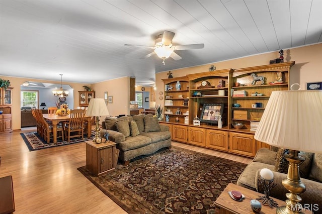 16785 County Road 624, Dexter, MO 63841 - living area featuring a ceiling fan, light wood-type flooring, and a chandelier