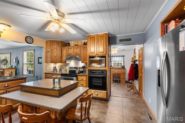 16785 County Road 624, Dexter, MO 63841 - kitchen featuring appliances with stainless steel finishes, a ceiling fan, a sink, dark countertops, and decorative backsplash