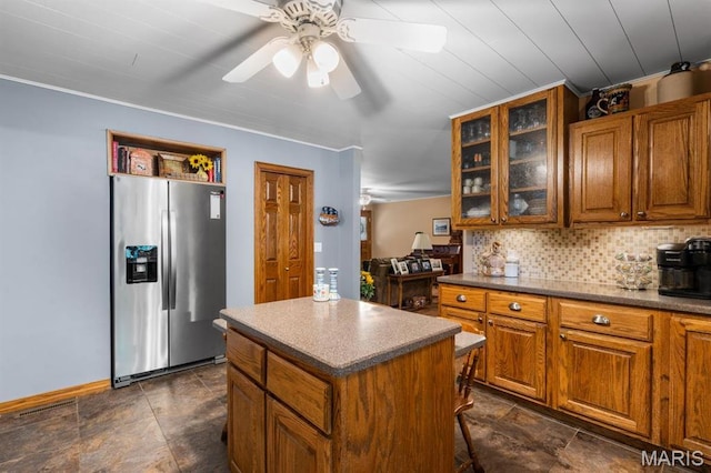 16785 County Road 624, Dexter, MO 63841 - kitchen featuring stainless steel fridge, brown cabinets, ceiling fan, and stone finish floors