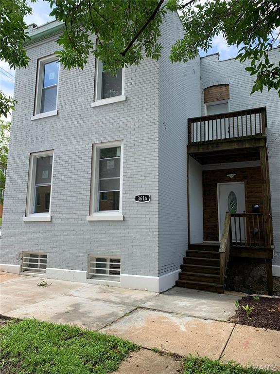 3616 Osceola St, Saint Louis, MO 63116 - rear view of property featuring brick siding, a balcony, and a patio