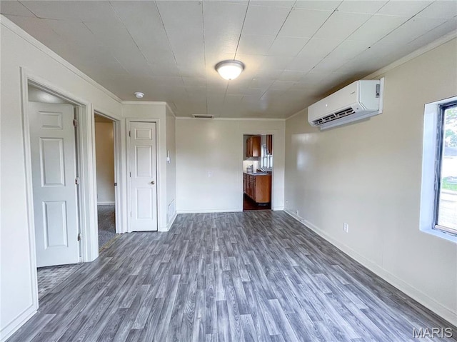 230 S Church St, Sullivan, MO 63080 - empty room featuring an AC wall unit, dark wood-style floors, ornamental molding, baseboards, and a smoke detector