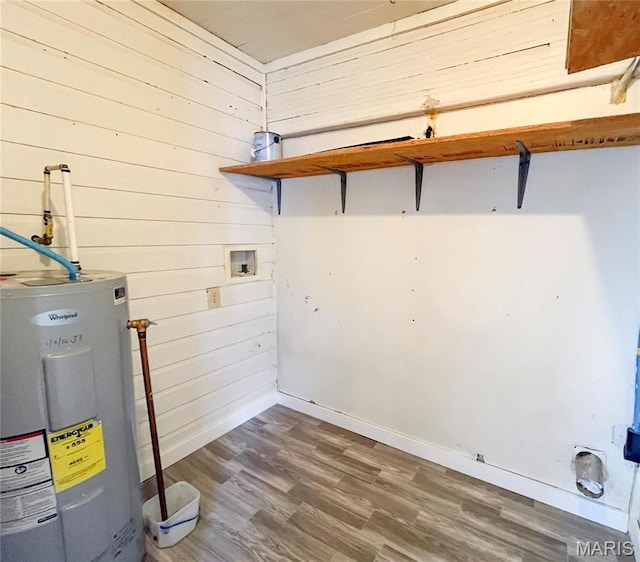 230 S Church St, Sullivan, MO 63080 - laundry room featuring electric water heater, wood finished floors, washer hookup, baseboards, and wooden walls