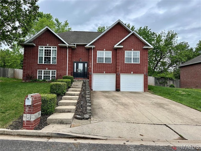 1324 Chelsea Ln, Rolla, MO 65401 - bi-level home featuring a garage, driveway, and brick siding
