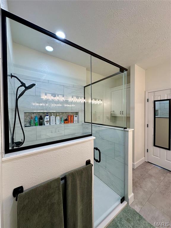 1324 Chelsea Ln, Rolla, MO 65401 - full bathroom with a shower stall, a textured ceiling, recessed lighting, tile patterned floors, and baseboards