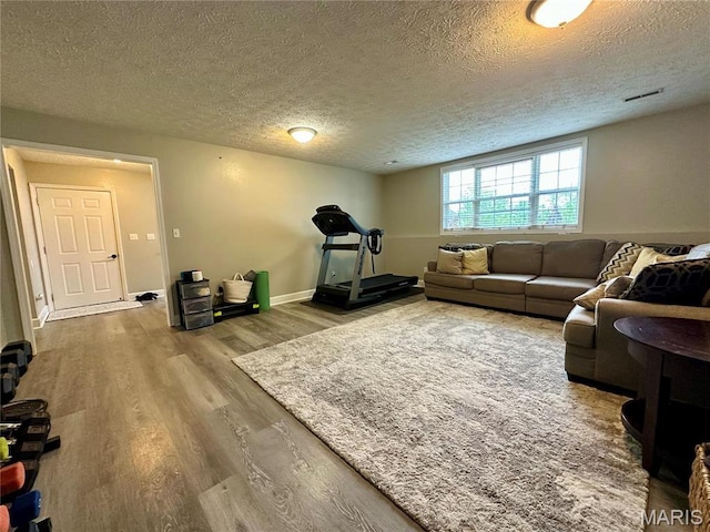 1324 Chelsea Ln, Rolla, MO 65401 - living room featuring wood finished floors, a textured ceiling, and baseboards