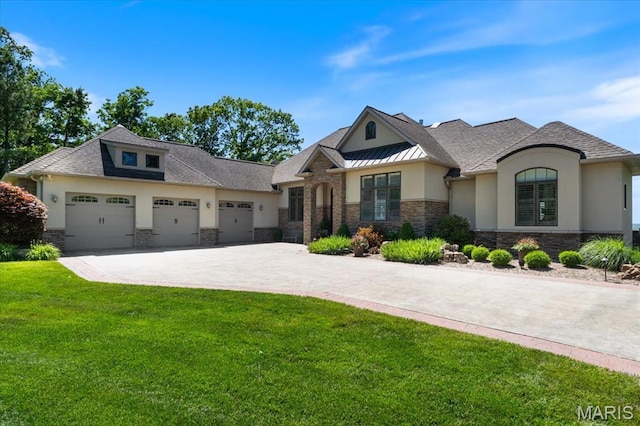 2308 Hh Rd, Waterloo, IL 62298 - view of front of property with stucco siding, stone siding, a front lawn, and an attached garage