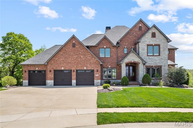 view of front of house featuring stone siding, concrete driveway, a front yard, a garage, and a shingled roof